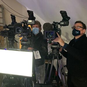 Two cameramen behind the cameras in the studio